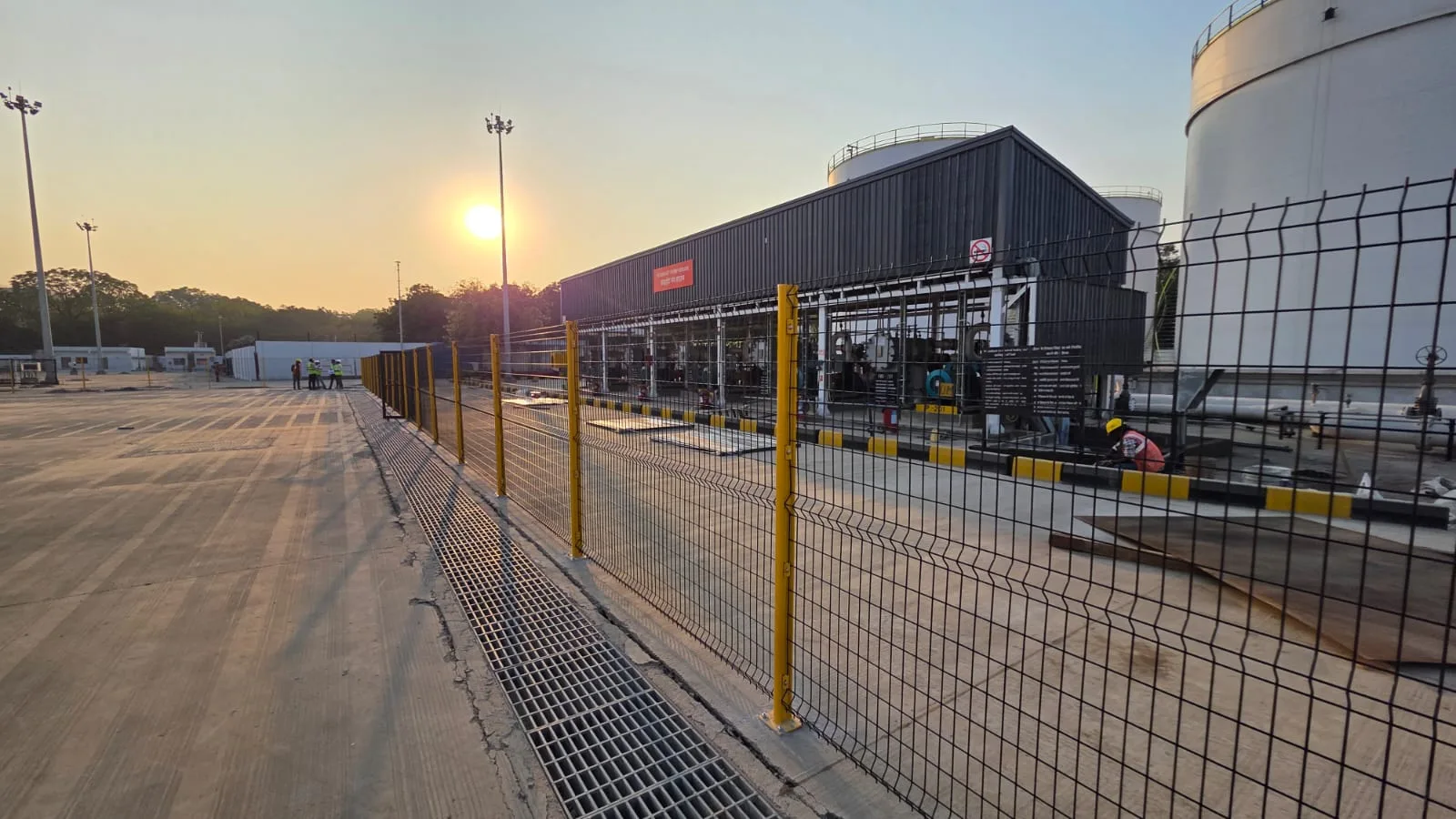 Yellow Nexus Indus-Shield safety fencing along the apron at Sardar Vallabhbhai Patel International Airport, Ahmedabad, at sunset